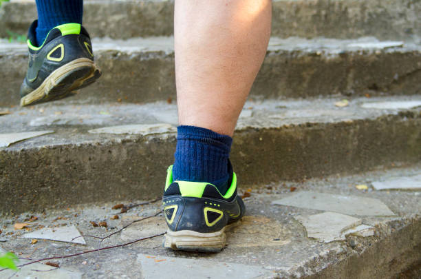 istock Man Footstep in sport sneakers.Persistent good attitude. Step by step successful concept. 827648290