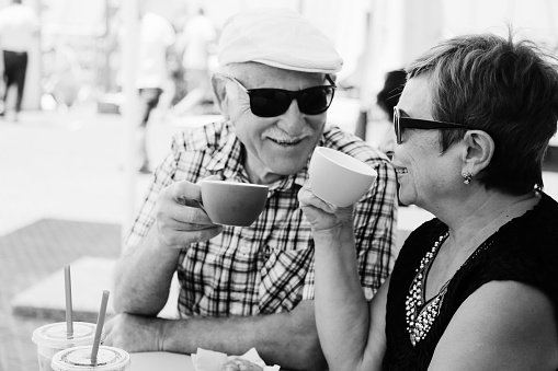 Portrait of senior woman sitting in summer cafe