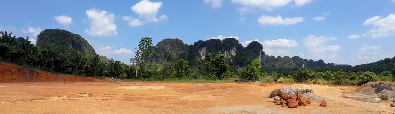 panorama landscape of land mountain and blue sky with clouds. near palm garden.