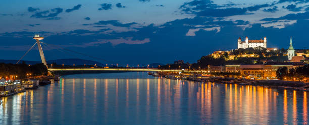 Night view on new bridge in Bratislava with castle on right side and lights reflection on Dunaj river.