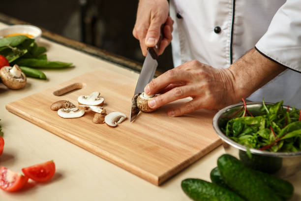 istock Mature man professional chef cooking meal indoors 827651758