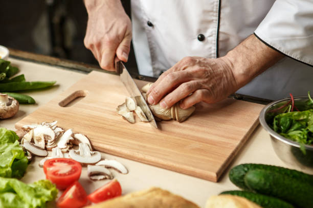 istock Mature man professional chef cooking meal indoors 827651872