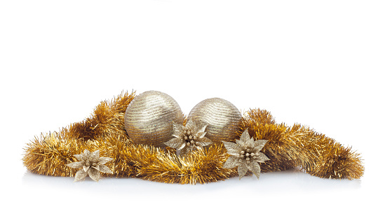 Golden Christmas arrangement against white background. Christmas balls, golden garland, flowers and spangles. Useful for banners