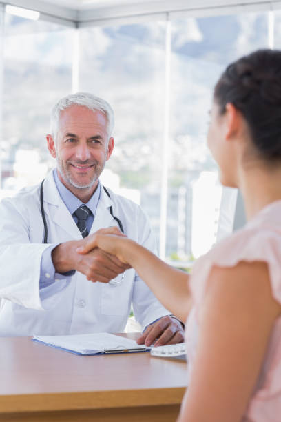 istock Patient shaking hands to doctor 827664326