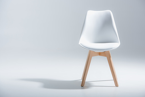 stylish chair with white top and light wooden legs standing on white