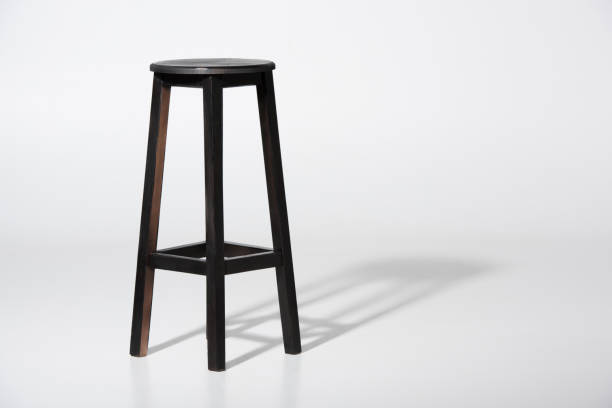 studio shot of classic black tall wooden barstool standing on white - stool imagens e fotografias de stock