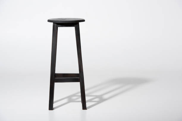 istock Studio shot of classic black tall wooden barstool standing on white 827668042