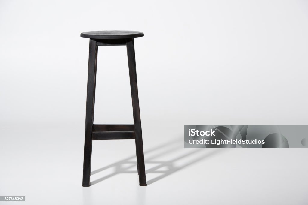 Studio shot of classic black tall wooden barstool standing on white Bar stool Stock Photo