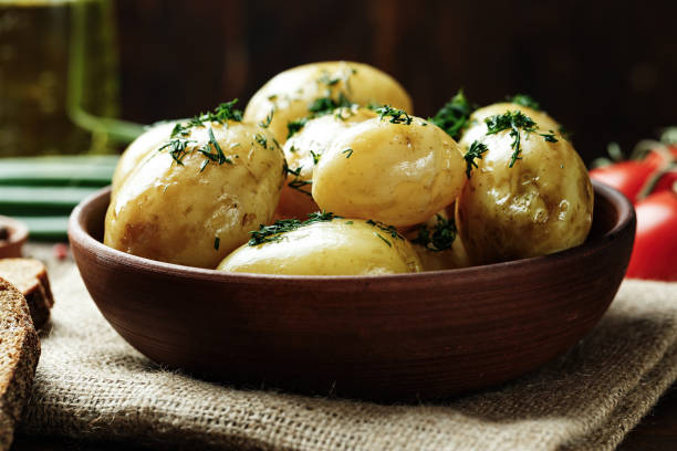 istock young potato in a clay plate 827676312