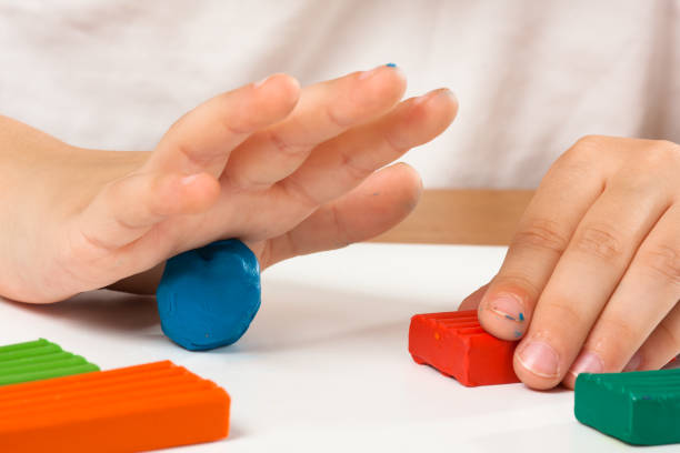istock hands of child with colourful clay 827676388