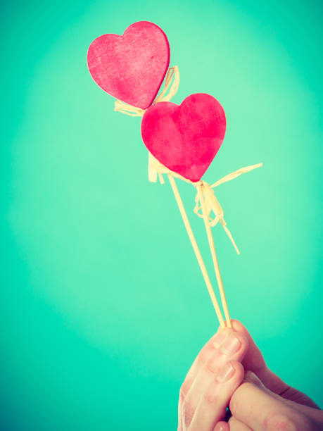 istock Male hand with little hearts on sticks. 827676764