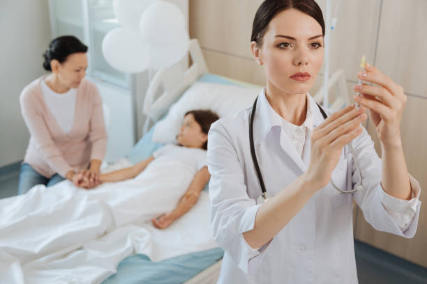 istock Smart serious doctor concentrating on her work 827676798