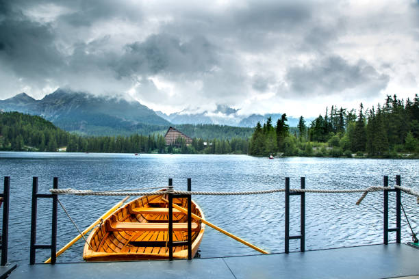 istock Wooden beautiful boat on a lake surrounded by mountains. 827676854