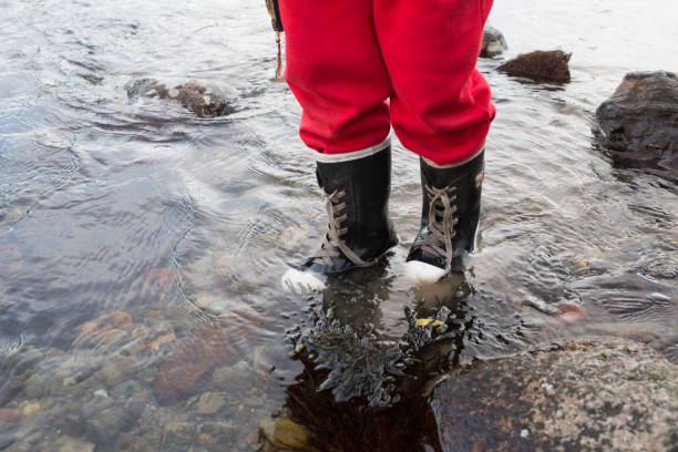 istock child in rubber boots is the river 827680052