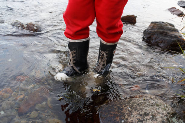 istock child in rubber boots is the river 827680142