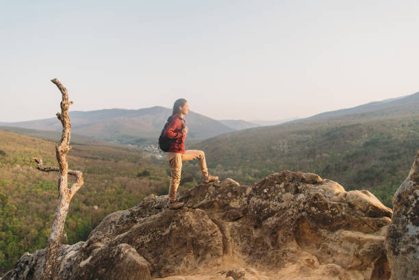 istock Hiker standing on peak of rock. 827692126