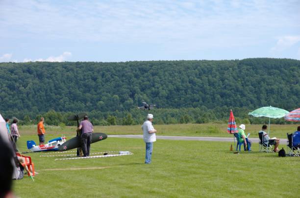 Aero L-39 Albatros Penza Oblast, Russia - July 15, 2017: People are watching how radio control flying model of Aero L-39 Albatros aircraft takeoff from runway. The Russian Aeromodelling Cup in Bolshoy Vyas village. aero l 39 albatros stock pictures, royalty-free photos & images