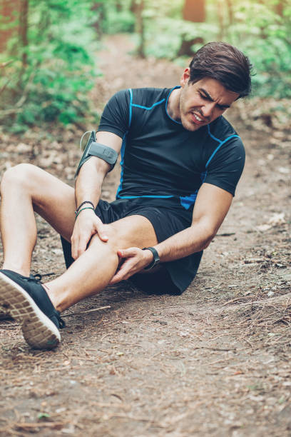 istock Injured athlete sitting on the ground 827692512