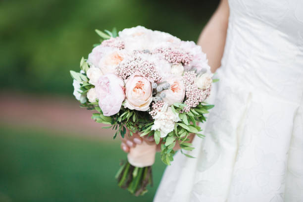 istock bride holds beautiful wedding bouquet 827698390