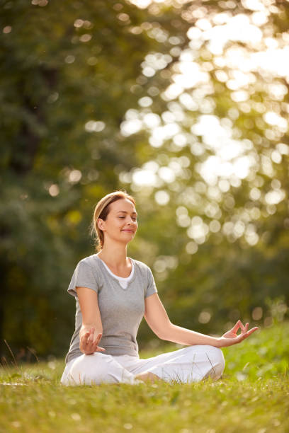 istock Meditation in yoga pose in forest 827698442