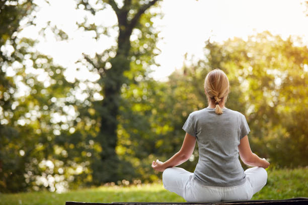 istock Woman practicing yoga in park 827699156