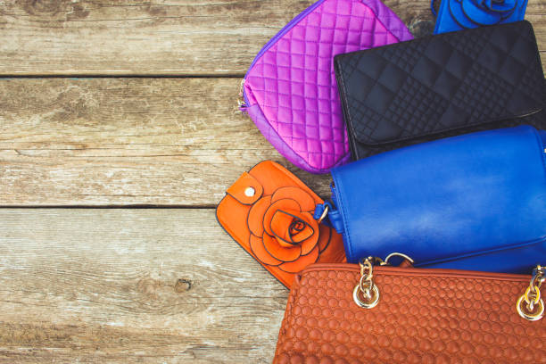 istock Colored handbags on wooden background. Top view. 827699352