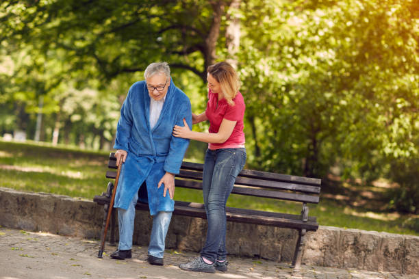istock smiling daughter helping disabled father in park 827699874