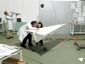 scientists constructing a plane in laboratory