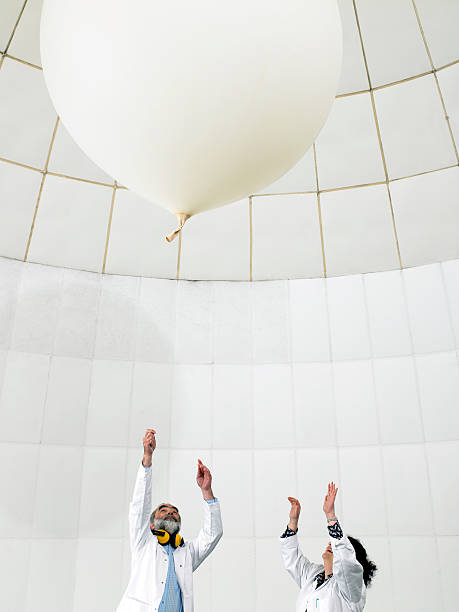 scientist watch balloon float away  weather balloon stock pictures, royalty-free photos & images