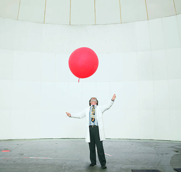 scientist looking up en globo del tiempo - globo del tiempo fotografías e imágenes de stock