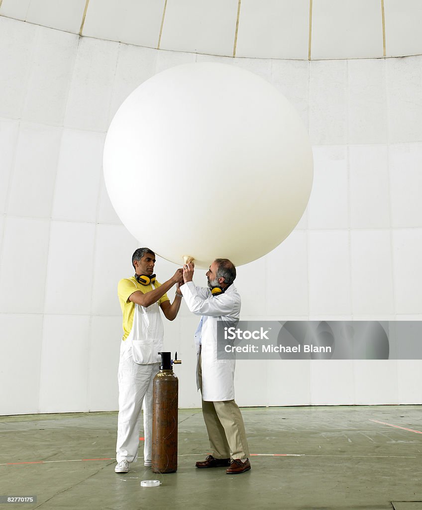 Scientists inflate weather balloon in lab  Challenge Stock Photo