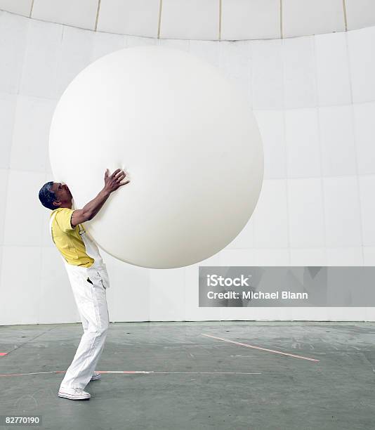 Man Holding Up Huge Balloon Stock Photo - Download Image Now - Balloon, Large, People