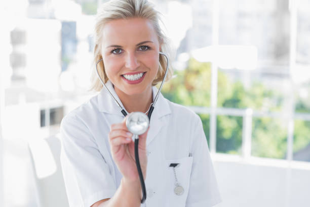 istock Radiant nurse showing her stethoscope 827705534