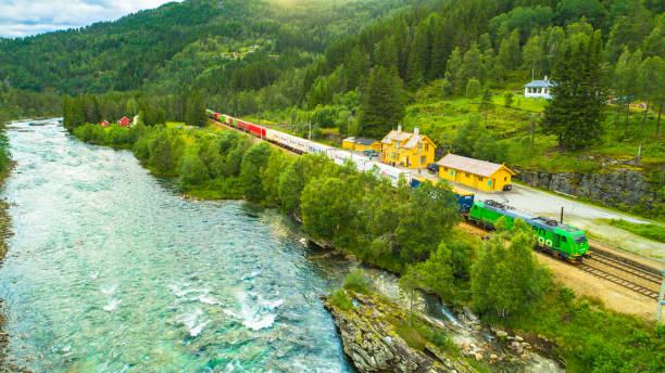 REIME, NORWAY - JULY 28, 2017: Cargo train Bergen - Oslo at Reimegrend train station in mountains.
