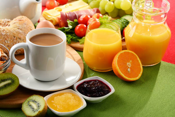 istock Breakfast served with coffee, orange juice, egg and fruits 827710842