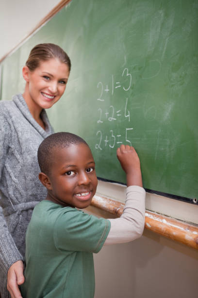 istock Portrait of a teacher explaining mathematics to a pupil 827711616