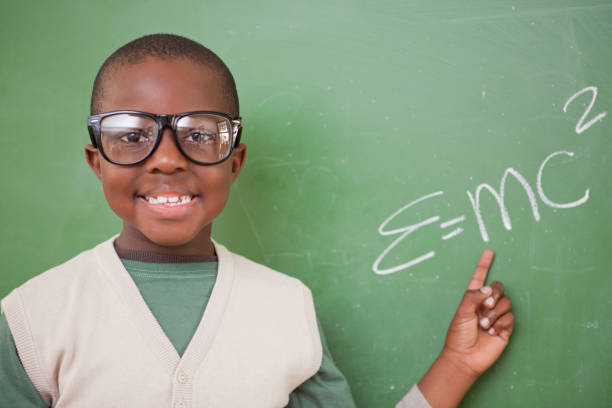 istock Schoolboy showing the the massenergy equivalence formula 827714320