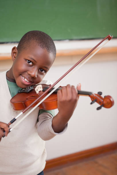 istock Portrait of a boy playing the violin 827714664