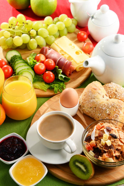 istock Breakfast served with coffee, orange juice, egg and fruits 827715268