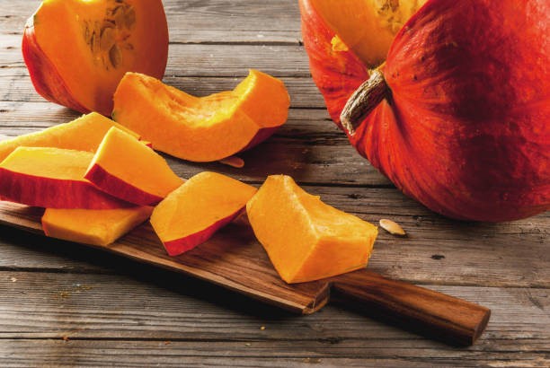 istock Raw pumpkin on wooden table 827721812