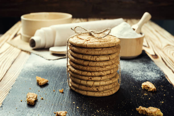 istock Biscuit sweet cookie background. Domestic stacked butter biscuit pattern concept,close up macro.Homemade cookies on wooden table.Cereal biscuits with the sesame,peanuts,sunflower and amaranth. 827729468