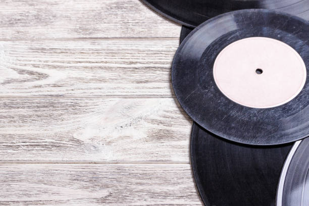 istock Scratched vinyl records on wooden background . Copy space for text. 827729770