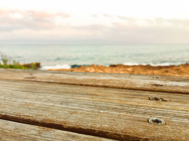 istock Wooden bench on sea background 827733568