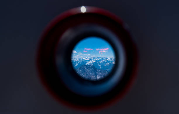 Alps mountain range looking from viewfinder of tourist binoculars on Zugspitze mountains stock photo