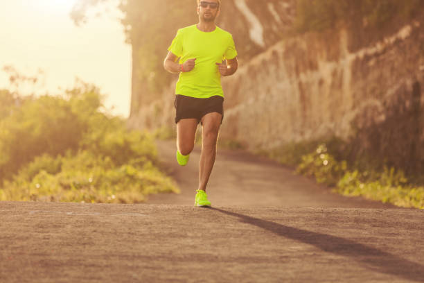 istock Jogging on the suburb road at sunset / sunrise time. 827747024