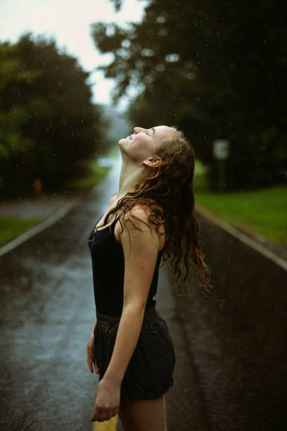 istock Happy girl outside in rain 827747164