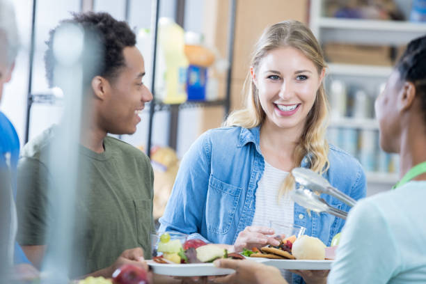 istock Happy couple receive meal in soup kitchen 827751024