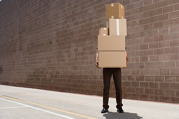 delivery-person carrying boxes  carrying stock pictures, royalty-free photos & images