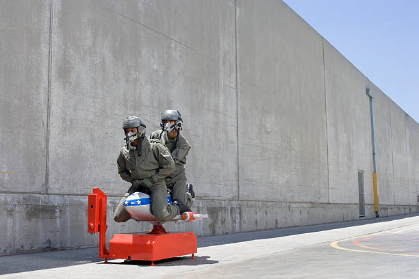 men in fighter pilot suits on toy jet ride  oxygen mask plane stock pictures, royalty-free photos & images