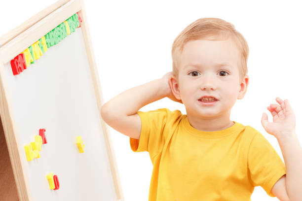 istock Child at the blackboard with numbers and letters makes up words. 827754296
